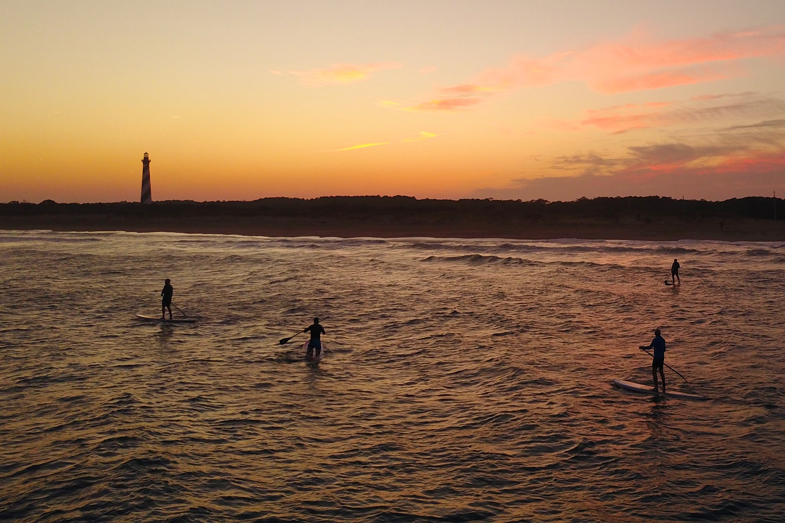 DJI Mavic shooting sunset SUP sessions at the Cape Hatteras lighthouse